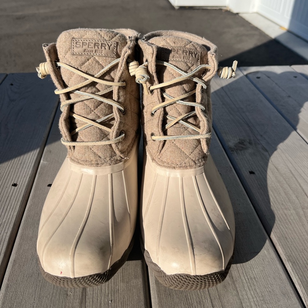 Tan and beige Sperry duck boots.